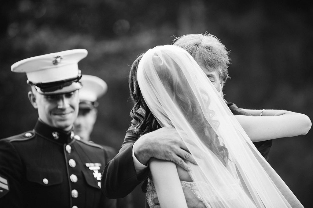 Black and White photo of the father of the bride kissing his daughter at the outdoor ceremony at The Wadsworth Mansion