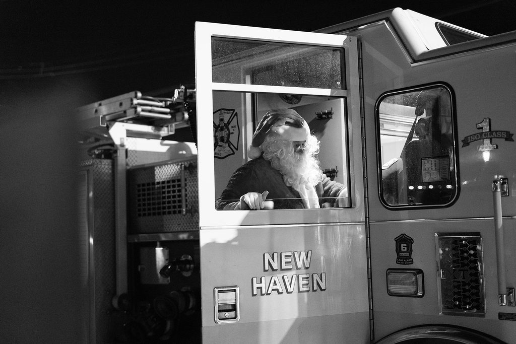 Black & White photo of Santa arriving on a New Haven fire truck at the Morris Cove tree lighting celebration.